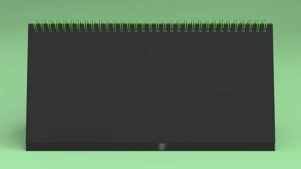 Schwarzer Tischkalender-Attrappe auf grüner Oberfläche — Stockfoto