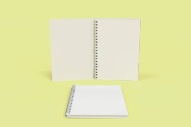 Sarı arka plan üzerinde iki defter spiral ile bağlı