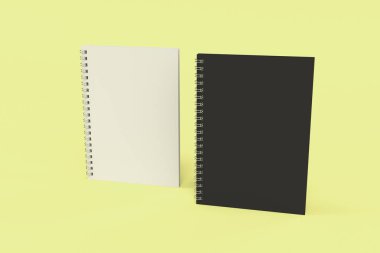 Sarı arka plan üzerinde iki defter spiral ile bağlı
