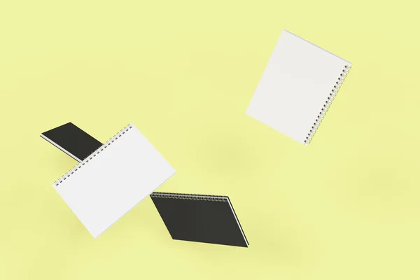 Quatro cadernos com encadernação em espiral em fundo amarelo — Fotografia de Stock