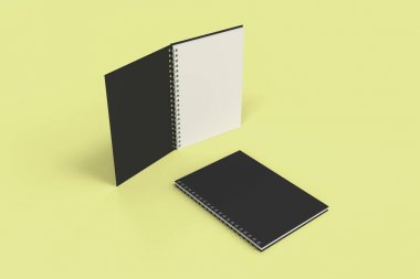 Sarı arka plan üzerinde iki defter spiral ile bağlı