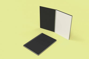 Sarı arka plan üzerinde iki defter spiral ile bağlı