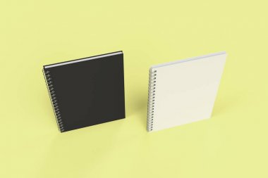 Sarı arka plan üzerinde iki defter spiral ile bağlı