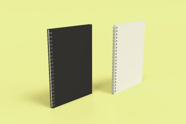 Sarı arka plan üzerinde iki defter spiral ile bağlı