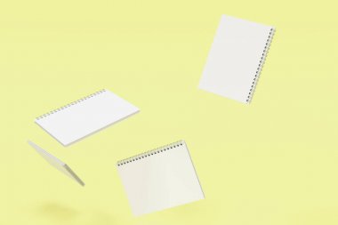 Sarı arka plan üzerinde dört defter spiral ile bağlı