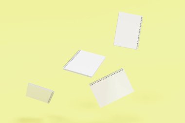 Sarı arka plan üzerinde dört defter spiral ile bağlı