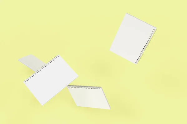 Four notebooks with spiral bound on yellow background — Stock Photo, Image