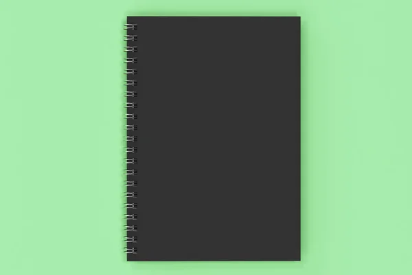 Closed notebook spiral bound on green background — Stock Photo, Image