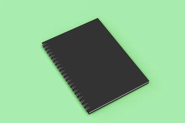 Caderno fechado espiral encadernado no fundo verde — Fotografia de Stock