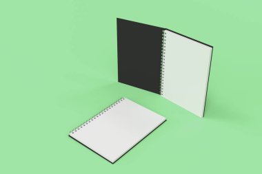 Yeşil arka plan üzerinde iki defter spiral ile bağlı