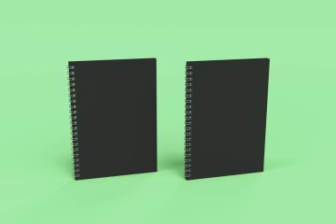 Yeşil arka plan üzerinde iki defter spiral ile bağlı