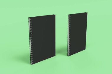 Yeşil arka plan üzerinde iki defter spiral ile bağlı
