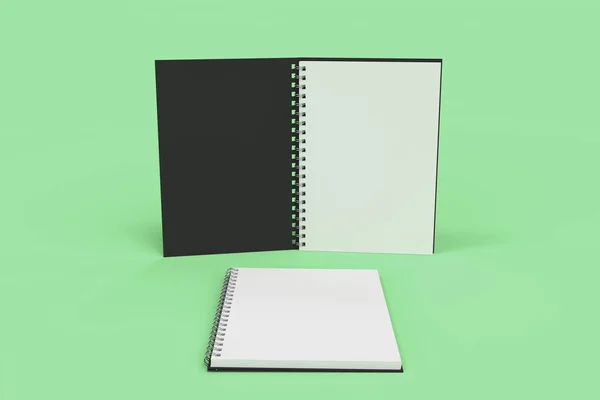 Dos cuadernos con espiral encuadernada sobre fondo verde —  Fotos de Stock