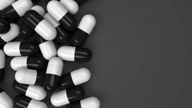 Siyah ve beyaz ilaç kapsül yığını