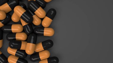Siyah ve turuncu ilaç kapsül yığını