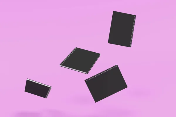 Чотири блокноти з спіральною пов'язкою на фіолетовому фоні — стокове фото