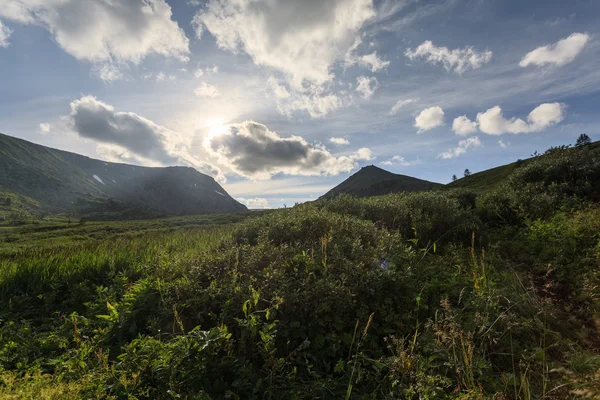 Sonne in den Wolken über dem Berg — Stockfoto