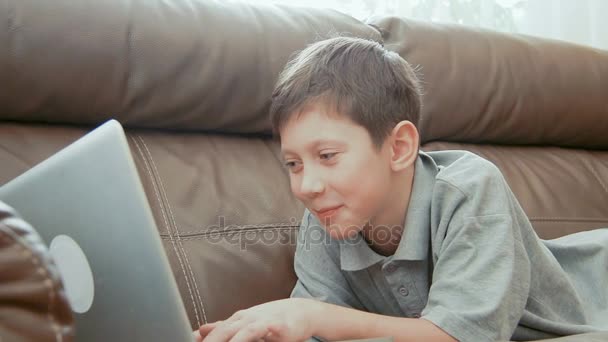 Leende liten pojke använder bärbar dator — Stockvideo