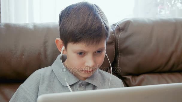 Little boy watching video on the laptop computer — Stock Video