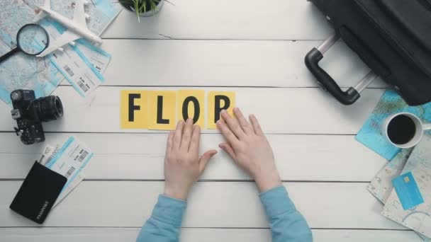 Вид сверху время истекло руки лежа на белом столе слово "FLORIDA" украшены дорожными предметами — стоковое видео