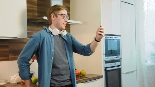 Young man having online video chat using smartphone — Stock Video