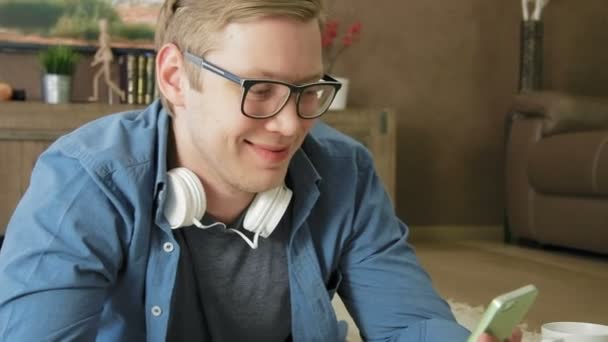 Hombre joven que tiene chat de vídeo en línea utilizando el teléfono inteligente — Vídeo de stock