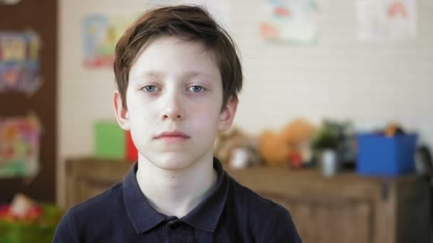 Портрет серьезного мальчика, смотрящего в камеру — стоковое видео