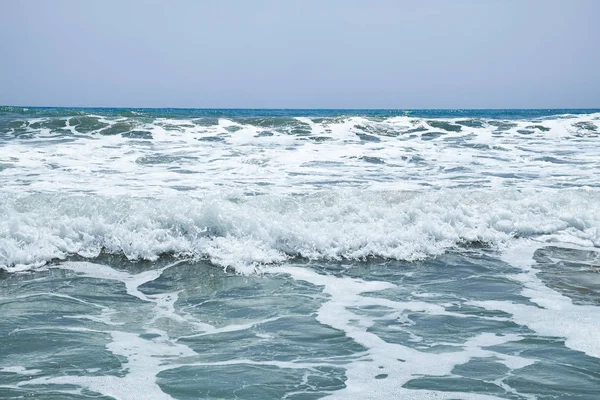 The surging waves of the Mediterranean on the beautiful beach Valencia in the summer sunny day. — Stock Photo, Image