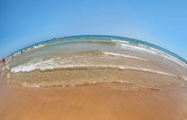 Wide angle sandy beach on the Mediterranean Sea, blue sky and sea, the fish-eye. — Stock Photo, Image