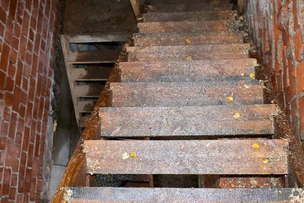 Natte houten trap in een bakstenen gebouw in aanbouw. — Stockfoto