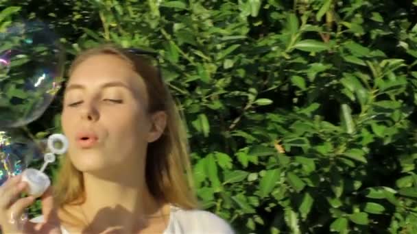 Cute girl blowing soap bubbles — Stock Video