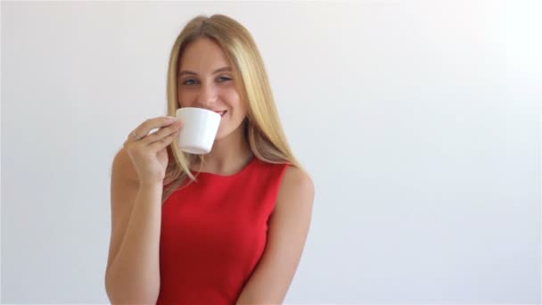 Young hot woman drinks coffee — Stock Video