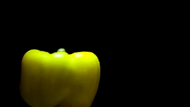 Delicious juicy pepper on black background — Stock Video