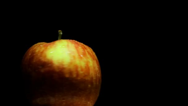 Delicious juicy apple on a black background — Stock Video