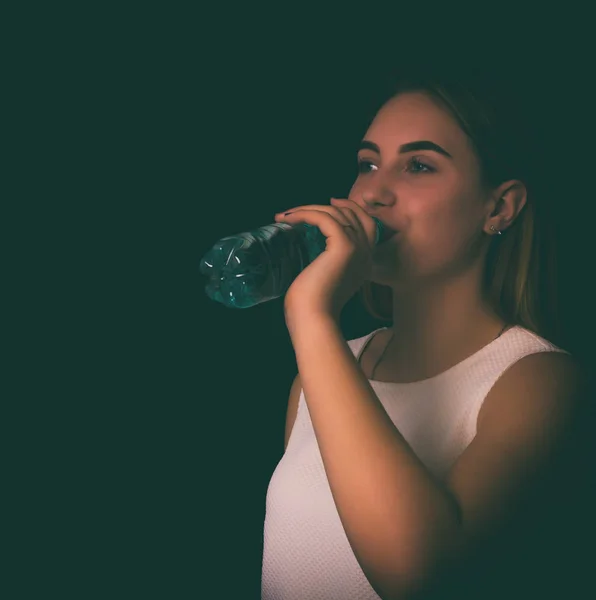 Young pretty woman drinks water Bottle or glass  of spring water — Stock Photo, Image