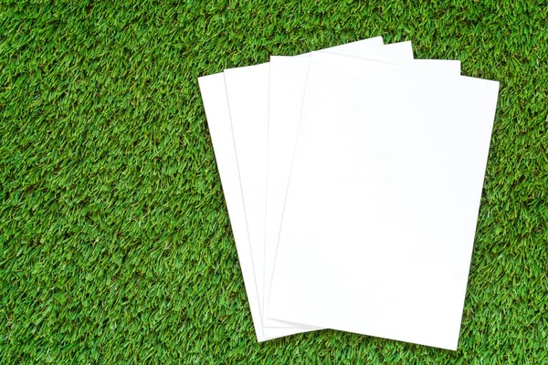 緑の芝生の上の空白のホワイト ペーパー — ストック写真
