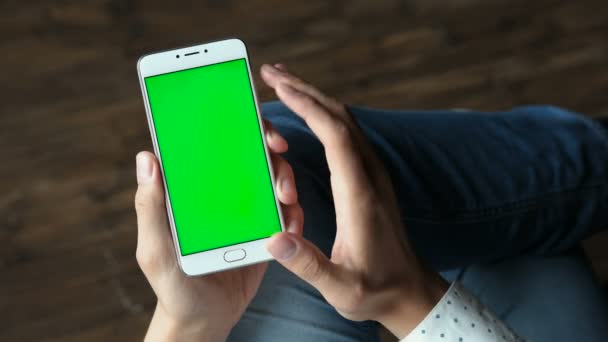 Mann benutzt Telefon mit grünem Bildschirm in Händen halten