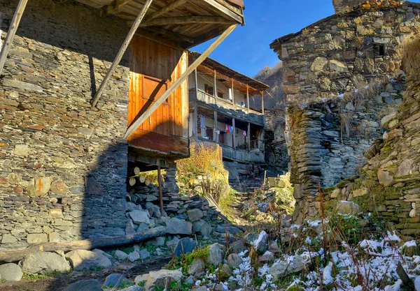 street in the small mountain village located in a privacy near majestic mountain tops, mountains are covered with snow, the Caucasian ridge