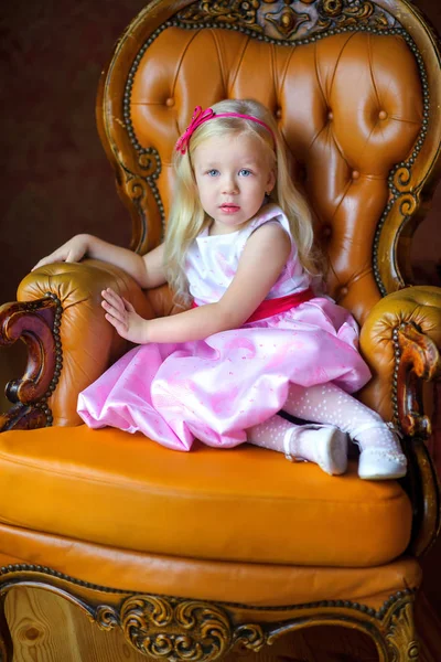 Beautiful little girl in a long pink dress — Stock Photo, Image