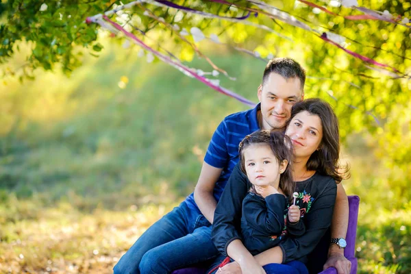 Happy family in the evening park — Stock Photo, Image