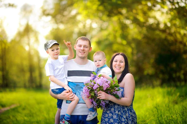 gün batımında parkta yürümek mutlu aile, kucaklamak ve gülümseme