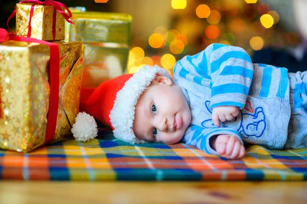 Happy Kid Santa Claus Hat Lies Floor Next Gifts Background — Stock Photo, Image