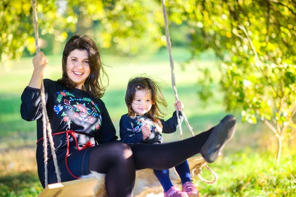 Happy Mother Riding Together Her Daughter Swing Evening Park — Stock Photo, Image