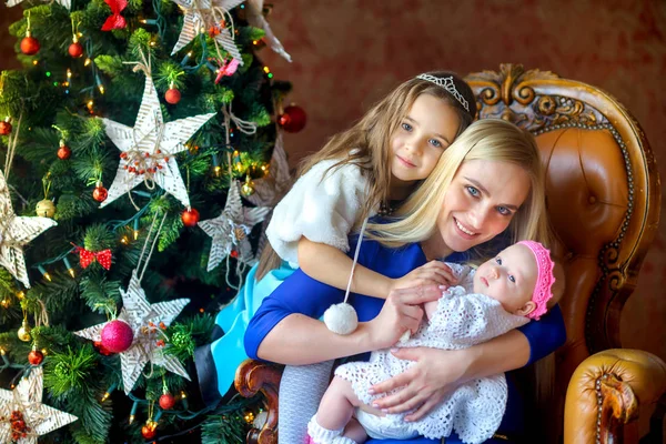 Happy family near the Christmas tree — Stock Photo, Image