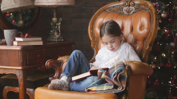 Girl Reading Fairytales Sitting Chair Christmas Tree — Stock Video