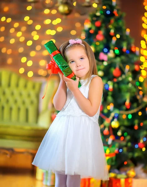 Cute Girl White Dress Stands Background Festive Christmas Tree Gift — Stock Photo, Image
