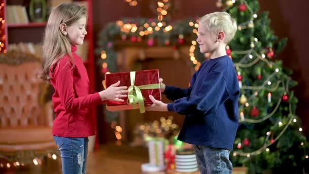 Los Niños Dan Regalos Mientras Están Pie Una Habitación Fondo — Vídeos de Stock