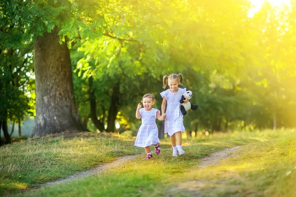 Gün Batımında Sevimli Çocuklar Parkta Yürüyor Kızlar Yol Boyunca Koşar Telifsiz Stok Fotoğraflar