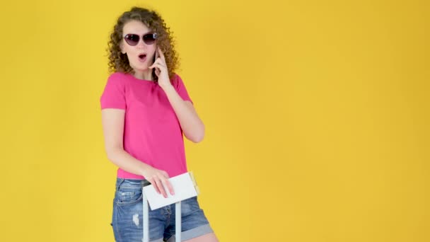 Attractive Young Girl Sunglasses Suitcase Ticket Using Smartphone Isolated Yellow — Stock Video