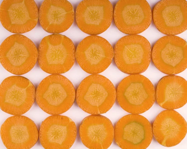 Carrot chopped circles view from above. Background of circles carrot. — Stock Photo, Image